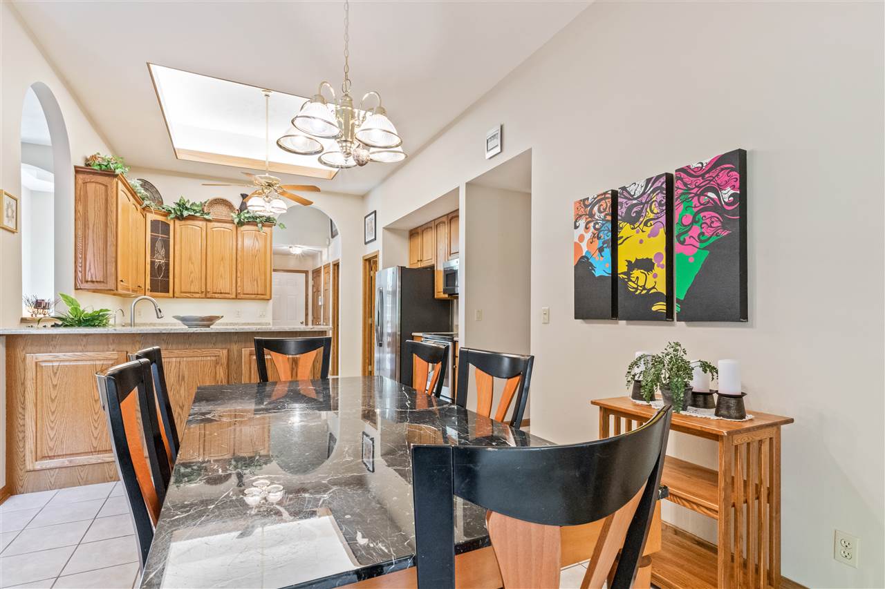 7272 Sentinel Road Rockford, IL 61107 - Photo 13 of 40 a view of a dining room with furniture a chandelier and wooden floor