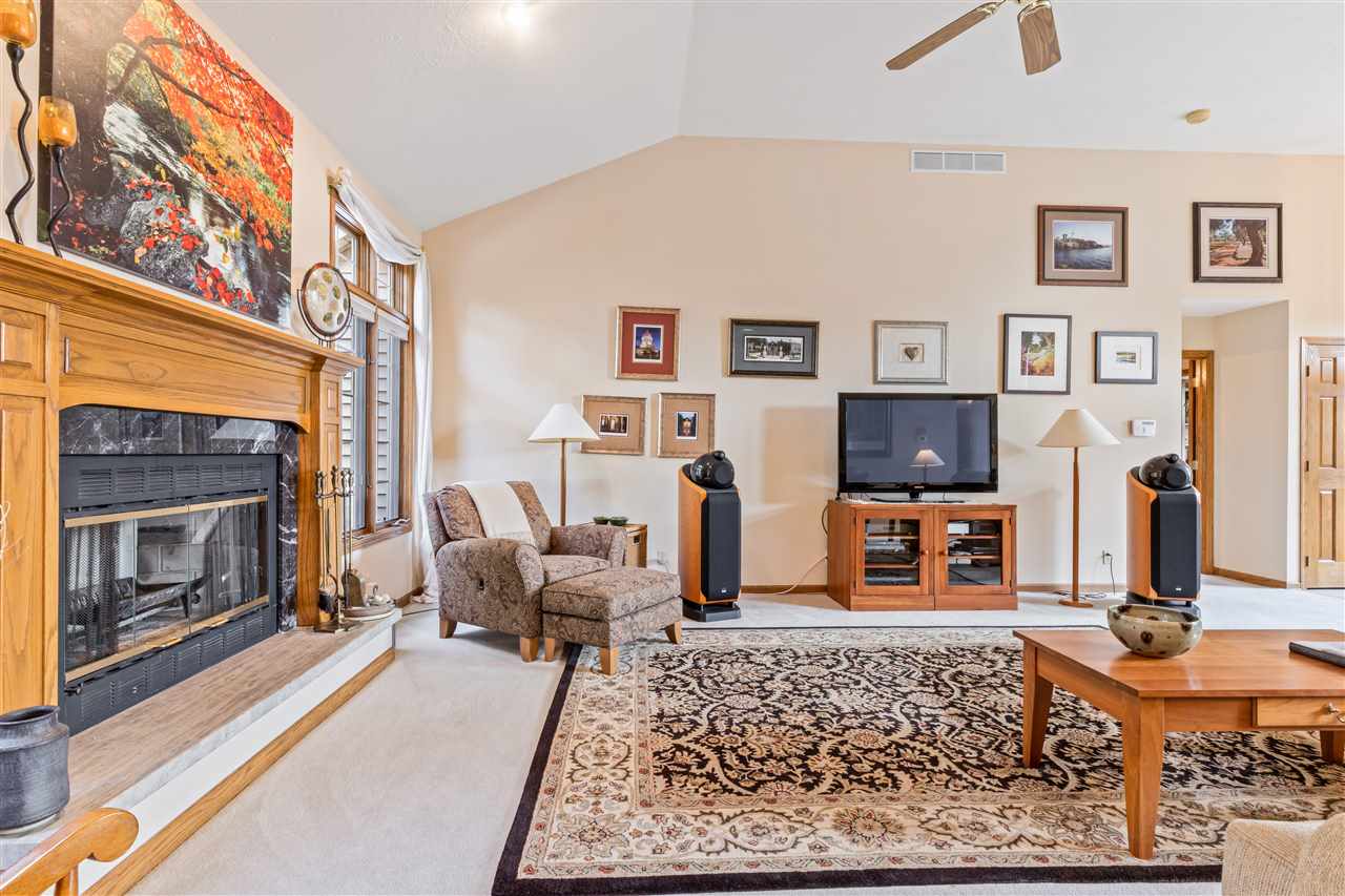 7272 Sentinel Road Rockford, IL 61107 - Photo 19 of 40 a living room with furniture a flat screen tv and a fireplace