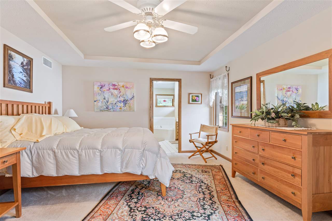7272 Sentinel Road Rockford, IL 61107 - Photo 25 of 40 a bedroom with a bed and a chandelier