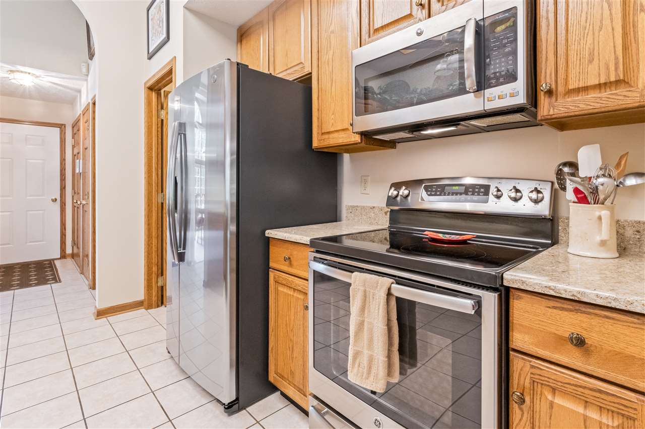 7272 Sentinel Road Rockford, IL 61107 - Photo 9 of 40 a kitchen with stainless steel appliances granite countertop a stove a microwave and a sink