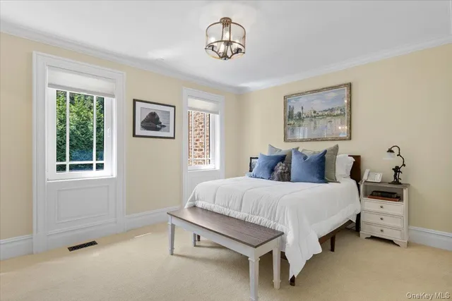 a spacious bedroom with a bed and a window