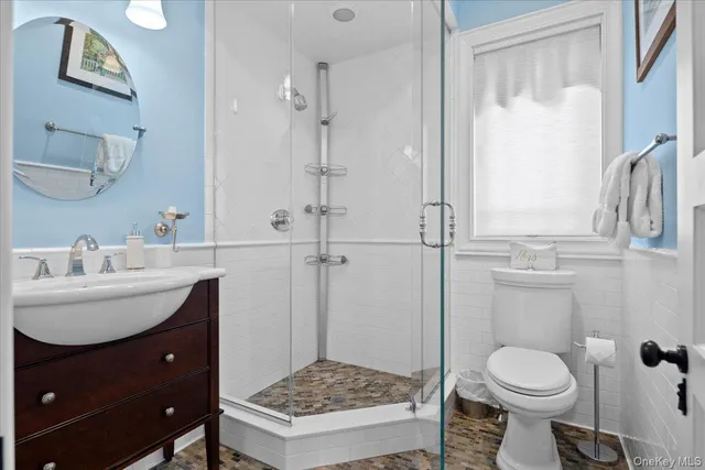 a bathroom with a sink toilet and shower
