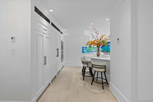 a dining room with furniture and painting on the wall