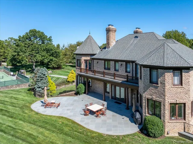 a aerial view of a house with a yard table and chairs