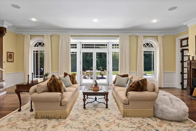 a living room with furniture and large windows