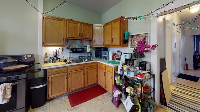 a kitchen with stainless steel appliances granite countertop a sink dishwasher and cabinets with wooden floor
