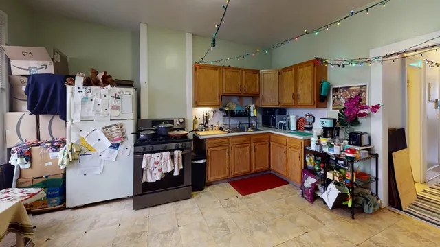 a kitchen with a refrigerator and a stove top oven