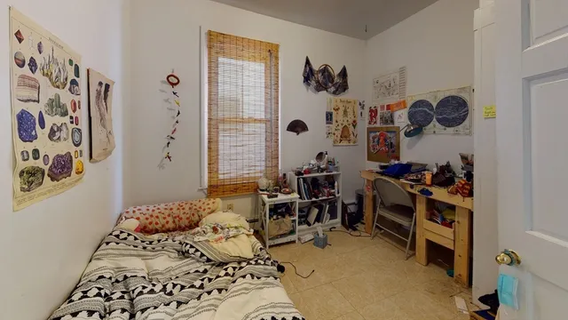 a bedroom with furniture and a window