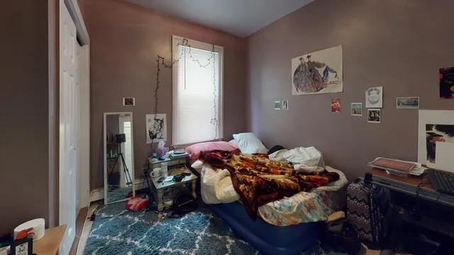 a bed room with a bed and a window