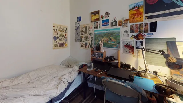 a bedroom with a bed and a table