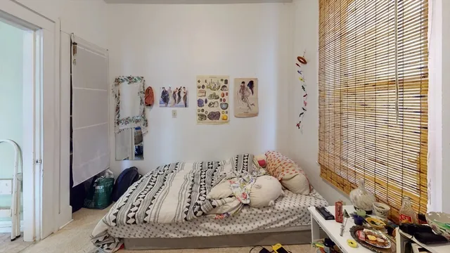 a bedroom with a bed and a window