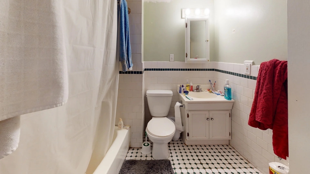 36 Mozart Street, Unit 2 Boston, MA 02130 - Photo 9 of 9 a bathroom with a sink a toilet and a mirror