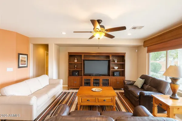 a living room with furniture a fireplace and a large window