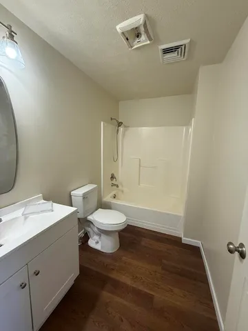 a bathroom with a toilet sink and a mirror