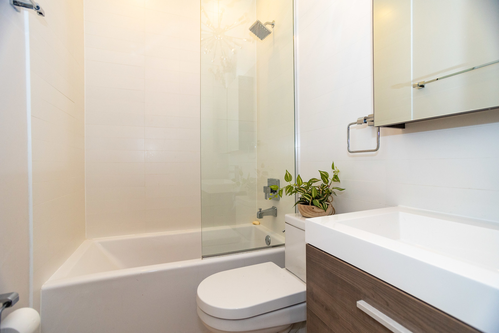 2453 West Irving Park Road, Unit 1E Chicago, IL 60618 - Photo 11 of 23 a bathroom with a sink a toilet and bathtub