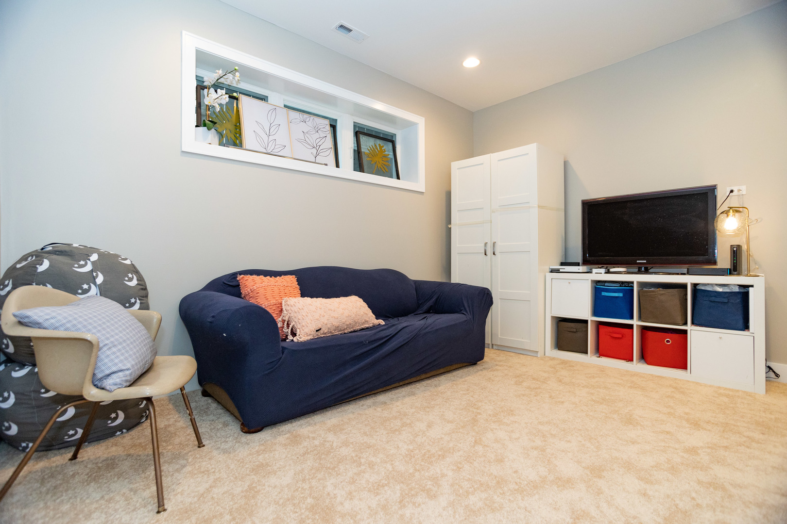 2453 West Irving Park Road, Unit 1E Chicago, IL 60618 - Photo 15 of 23 a living room with furniture and a flat screen tv
