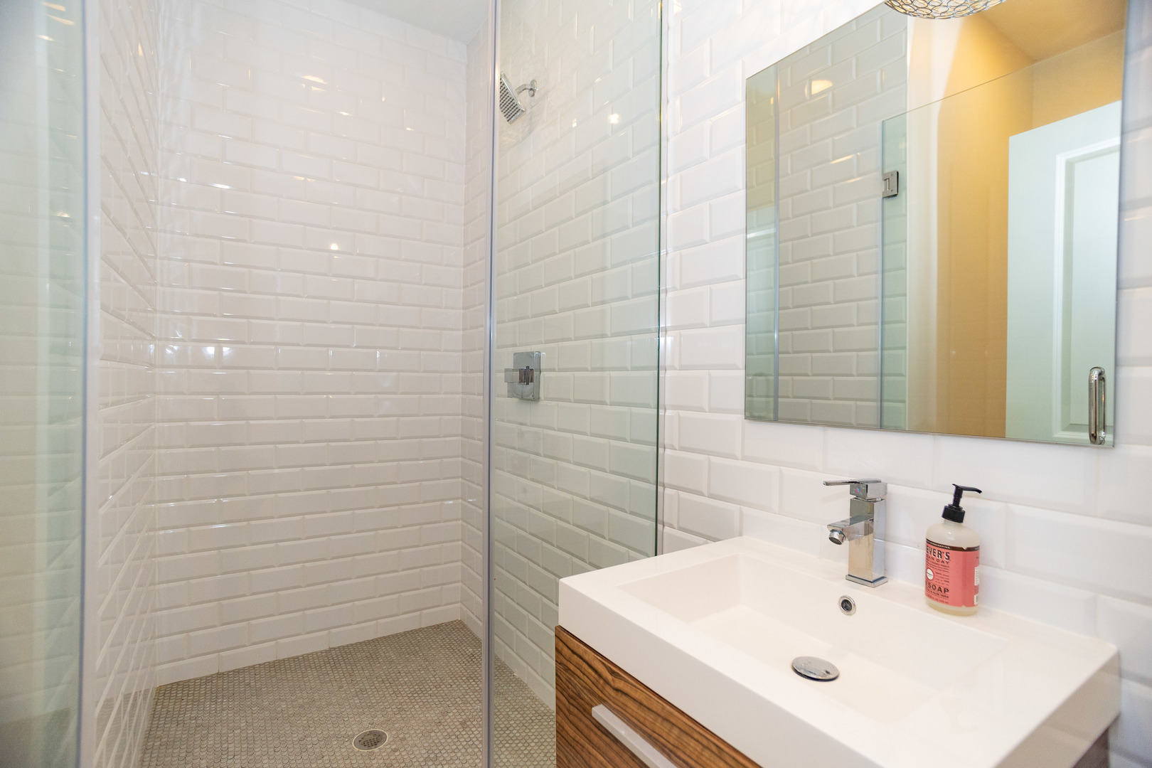 2453 West Irving Park Road, Unit 1E Chicago, IL 60618 - Photo 18 of 23 a bathroom with a sink a shower and a mirror