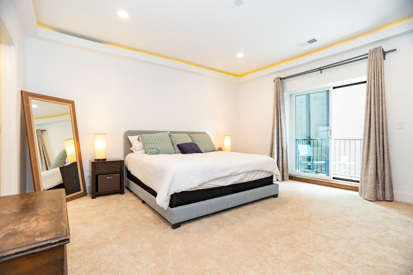 2453 West Irving Park Road, Unit 1E Chicago, IL 60618 - Photo 8 of 23 a bed sitting in a spacious bedroom next to a window