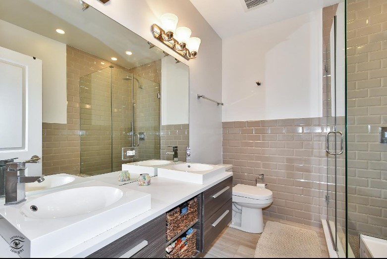 2453 West Irving Park Road, Unit 1E Chicago, IL 60618 - Photo 9 of 23 a bathroom with a sink a toilet and shower