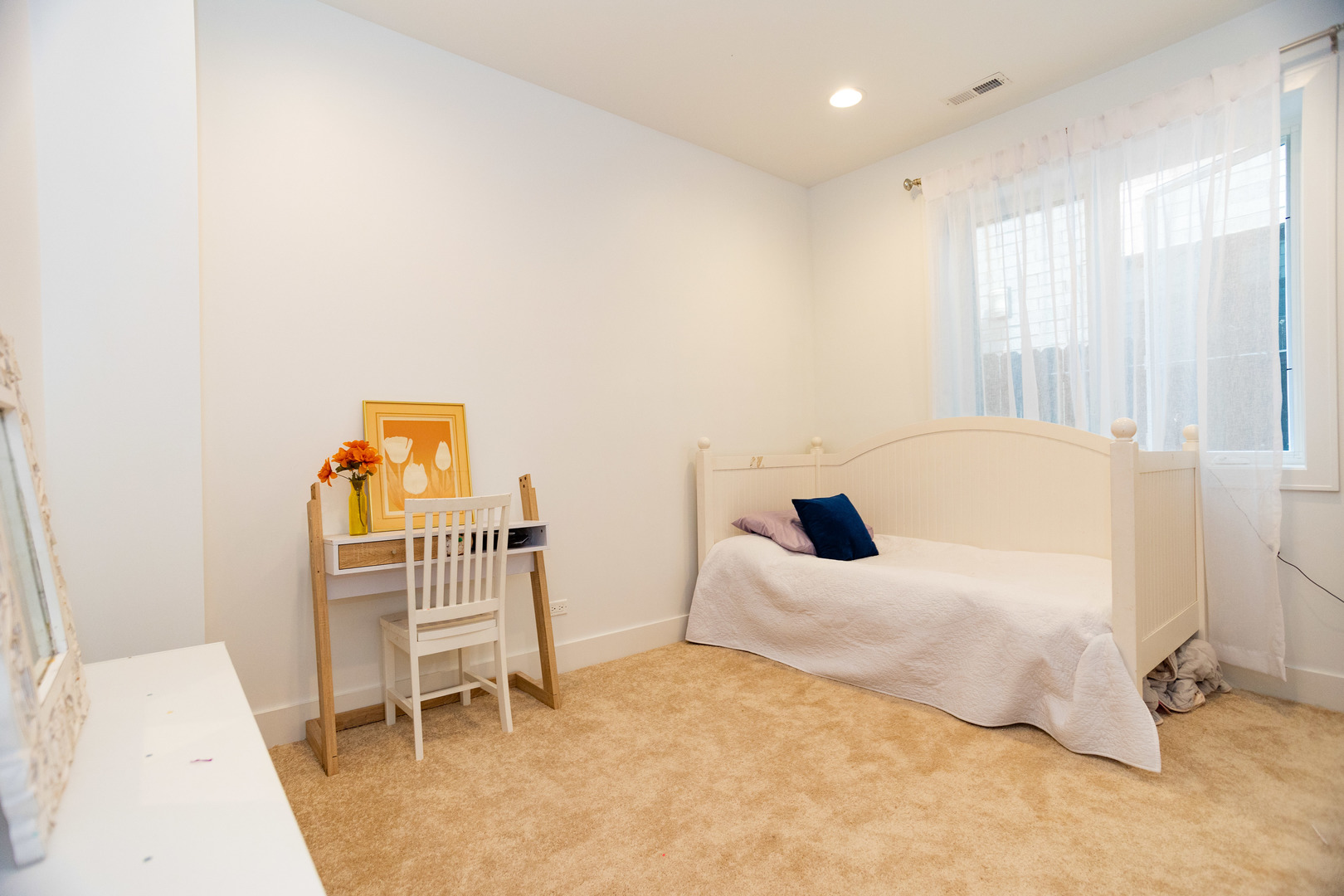 2453 West Irving Park Road, Unit 1E Chicago, IL 60618 - Photo 10 of 23 a bedroom with a bed and a chair