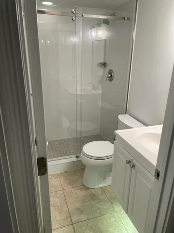 a bathroom with a toilet a sink and shower