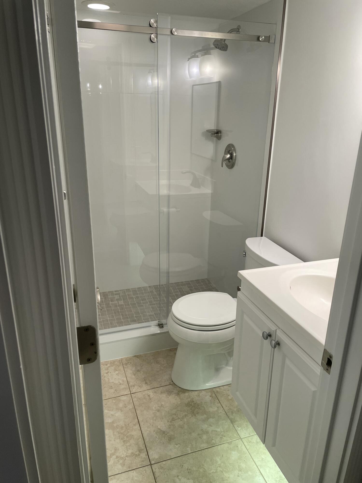 765 Jeffery Street, Unit 1301 Boca Raton, FL 33487 - Photo 11 of 31 a bathroom with a toilet a sink and shower