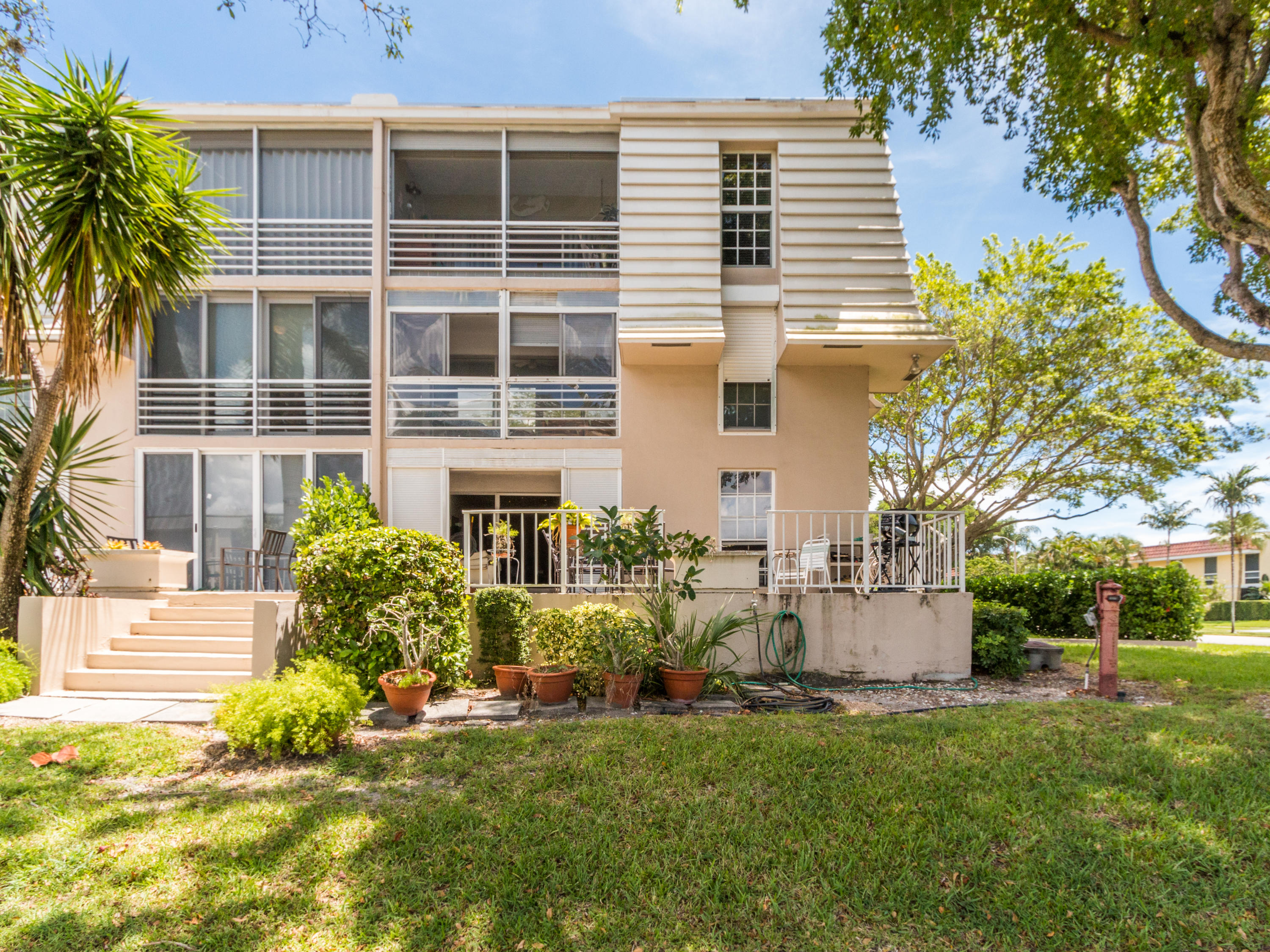765 Jeffery Street, Unit 1301 Boca Raton, FL 33487 - Photo 22 of 31 a front view of a house with a yard