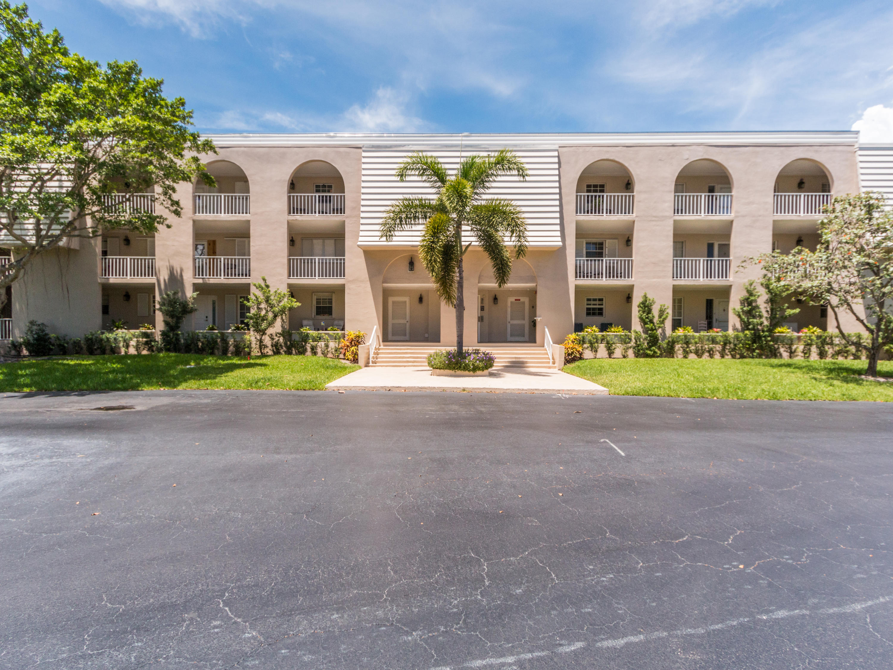 765 Jeffery Street, Unit 1301 Boca Raton, FL 33487 - Photo 23 of 31 a front view of a house with a yard