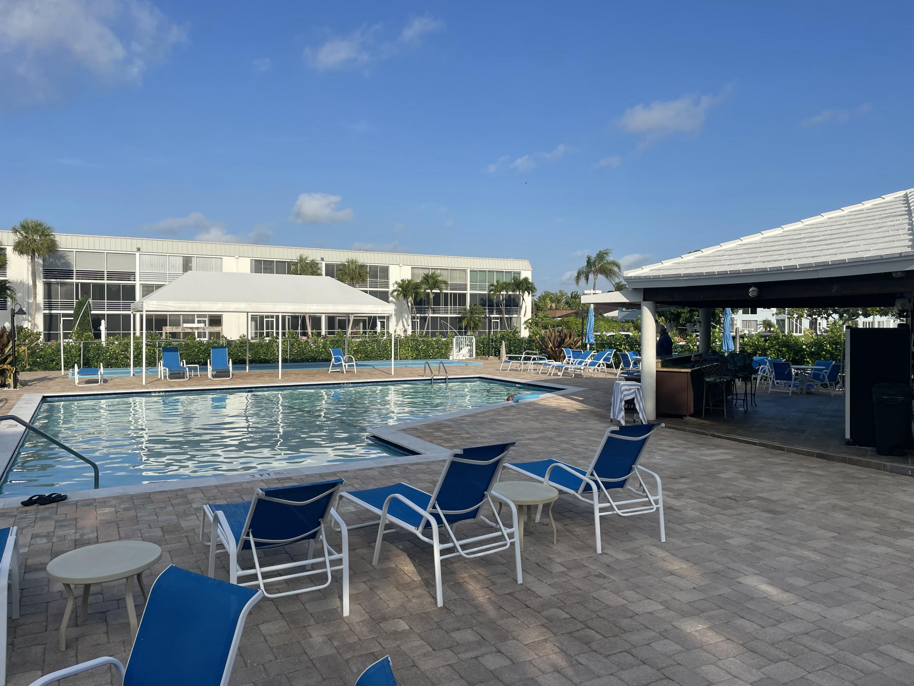 765 Jeffery Street, Unit 1301 Boca Raton, FL 33487 - Photo 24 of 31 a patio with glass top table and chairs