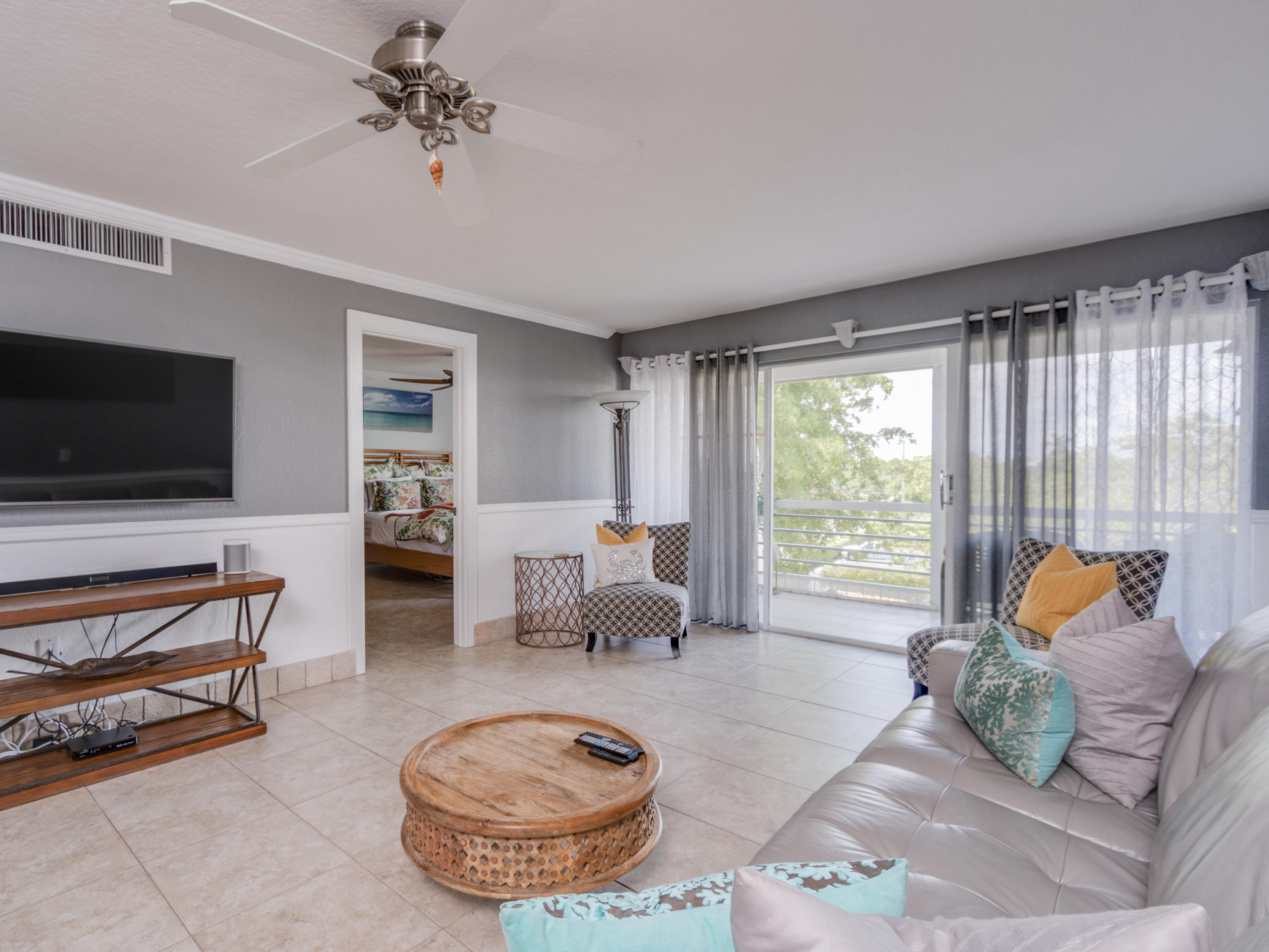765 Jeffery Street, Unit 1301 Boca Raton, FL 33487 - Photo 8 of 31 a living room with furniture and a flat screen tv