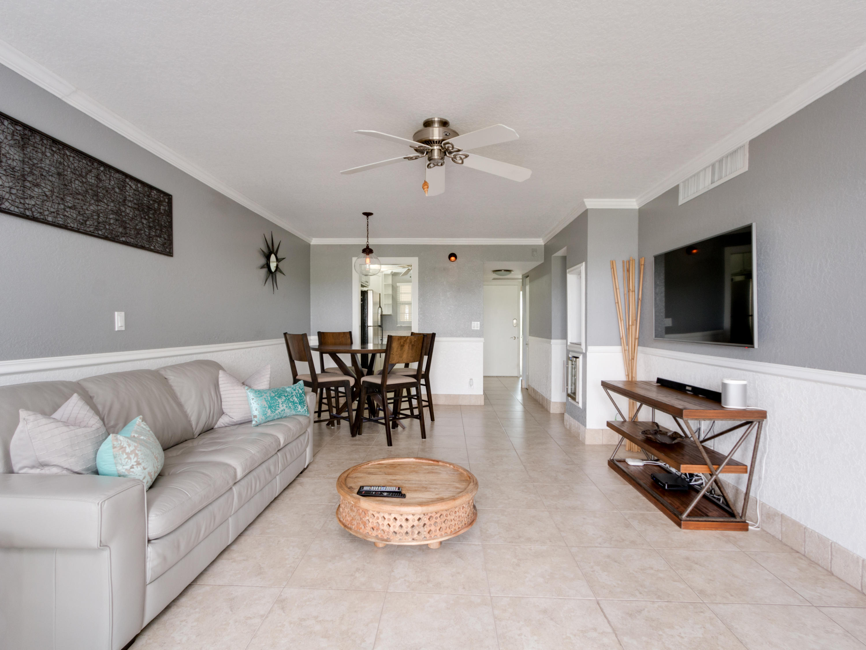 765 Jeffery Street, Unit 1301 Boca Raton, FL 33487 - Photo 9 of 31 a living room with furniture and a flat screen tv