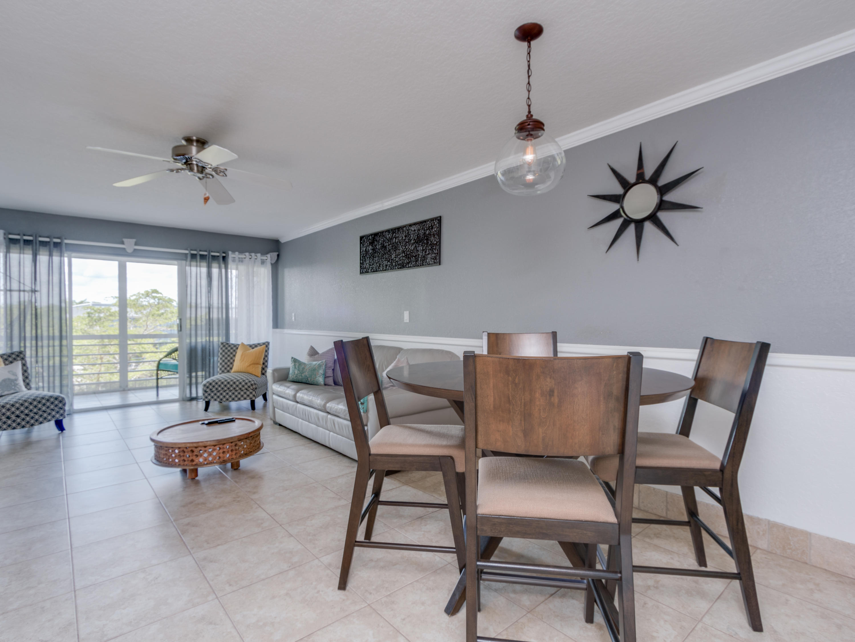 765 Jeffery Street, Unit 1301 Boca Raton, FL 33487 - Photo 10 of 31 a living room with furniture and a chandelier