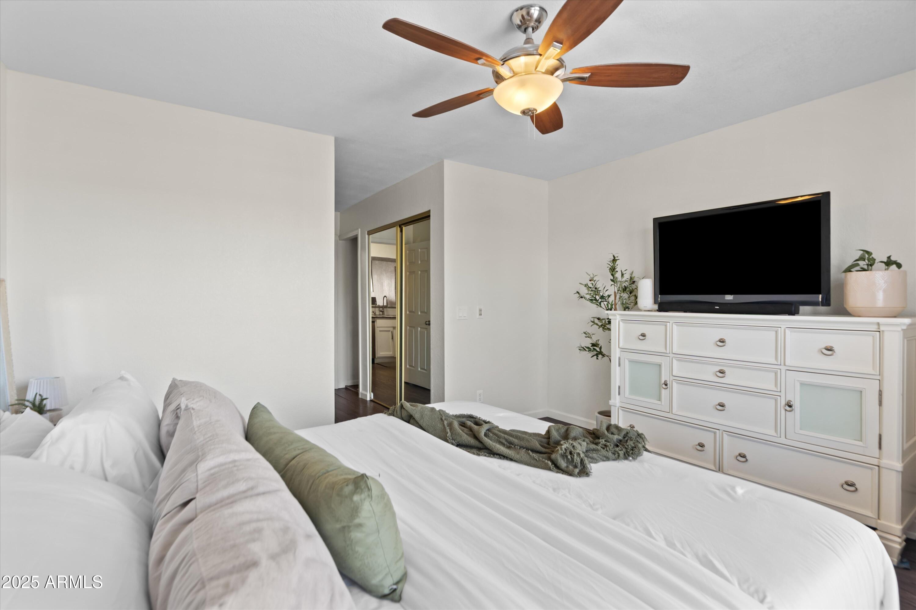 2333 East Southern Avenue, Unit 2067 Tempe, AZ 85282 - Photo 13 of 32 a bedroom with a bed and a flat screen tv