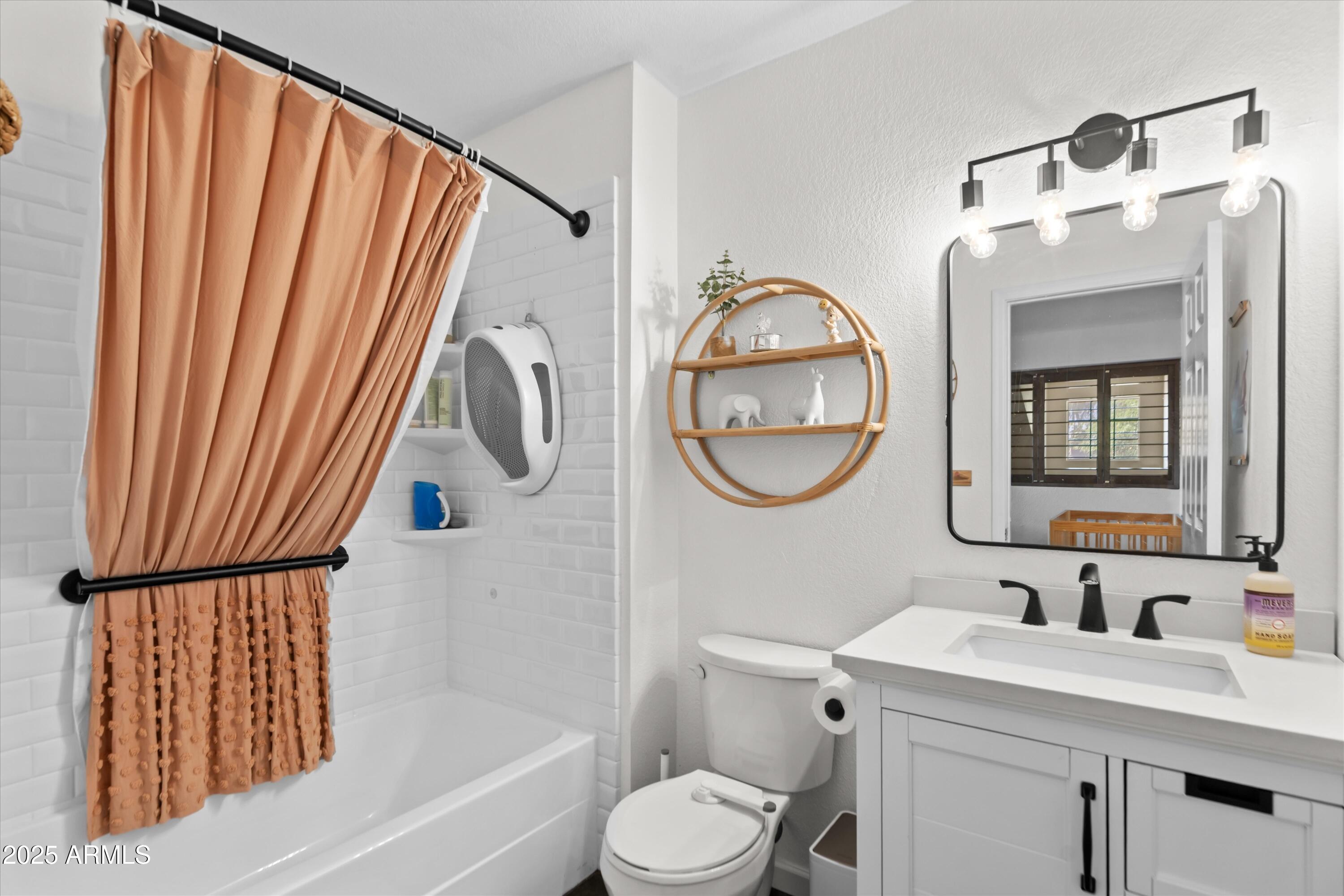 2333 East Southern Avenue, Unit 2067 Tempe, AZ 85282 - Photo 18 of 32 a bathroom with a sink a toilet and a mirror