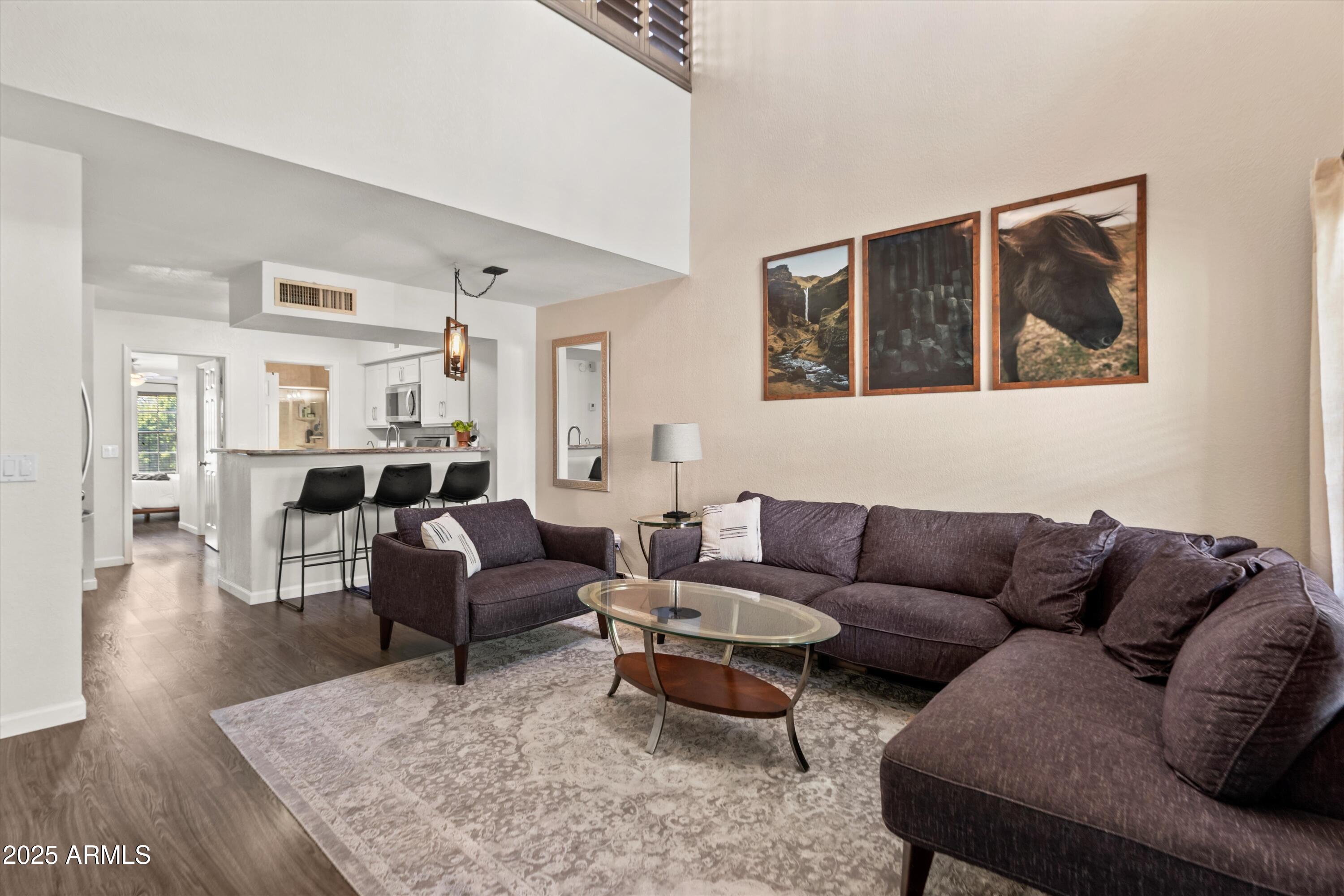 2333 East Southern Avenue, Unit 2067 Tempe, AZ 85282 - Photo 8 of 32 a living room with furniture wooden floor and a large window