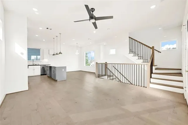 a view of a kitchen with furniture and a ceiling fan