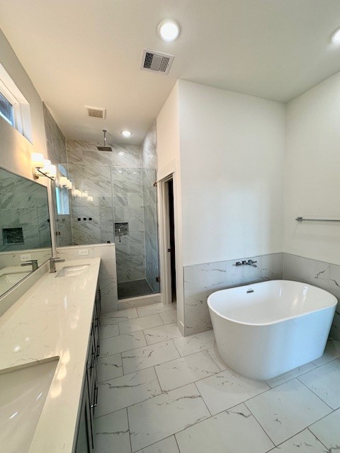 4623 Cochran Street Houston, TX 77009 - Photo 6 of 12 a spacious bathroom with a tub a sink a mirror and a shower