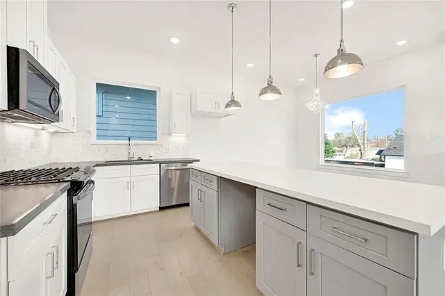a kitchen with a sink stove and microwave
