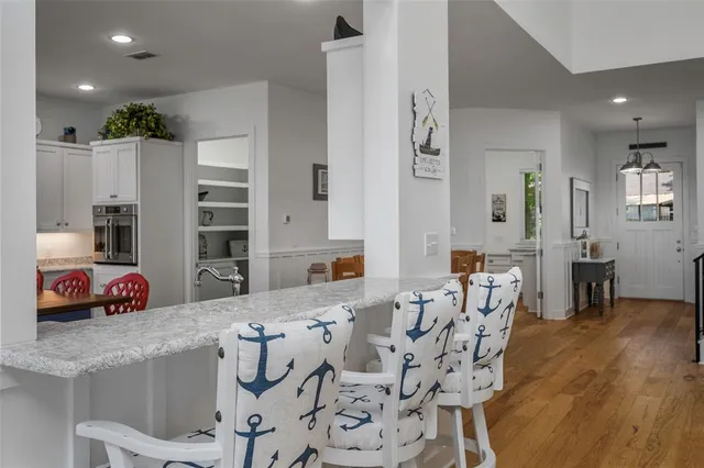 a kitchen with stainless steel appliances kitchen island granite countertop a stove a sink and a refrigerator