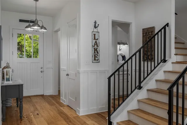 a large white kitchen with a large window a sink and stainless steel appliances