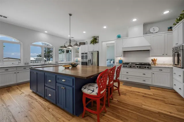 a spacious bathroom with a granite countertop sink and a mirror