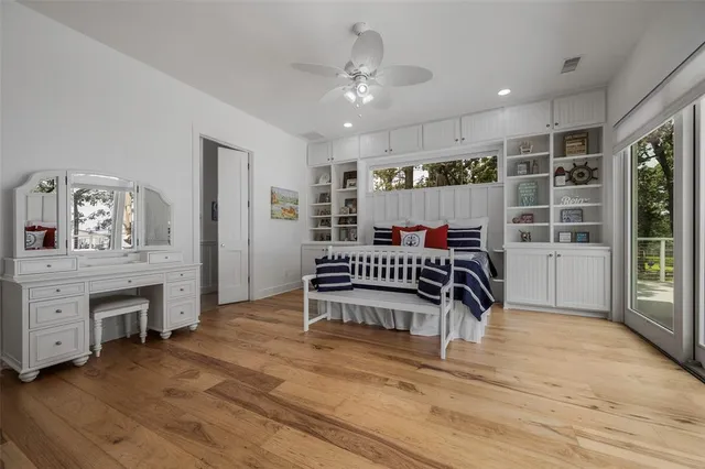 a spacious bathroom with double sink a mirror and a toilet