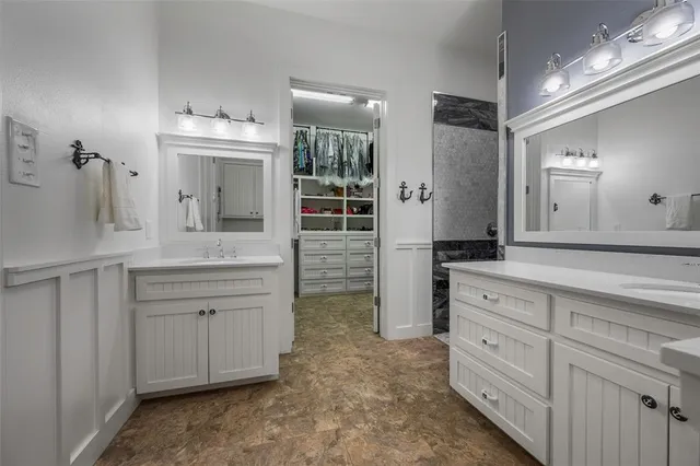 a front view of a house with a garden and trees