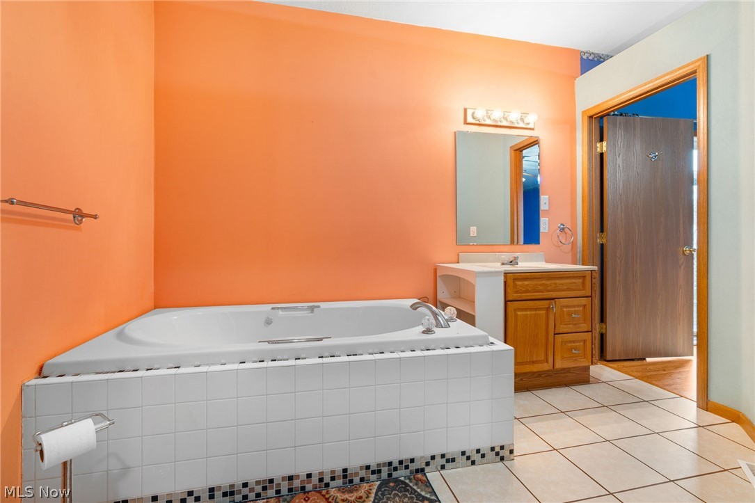 1640 Old Delaware Road Mount Vernon, OH 43050 - Photo 22 of 49 Full bathroom with vanity, light tile patterned floors, and a bath