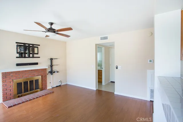 a view of a livingroom with a fireplace and a ceiling fan