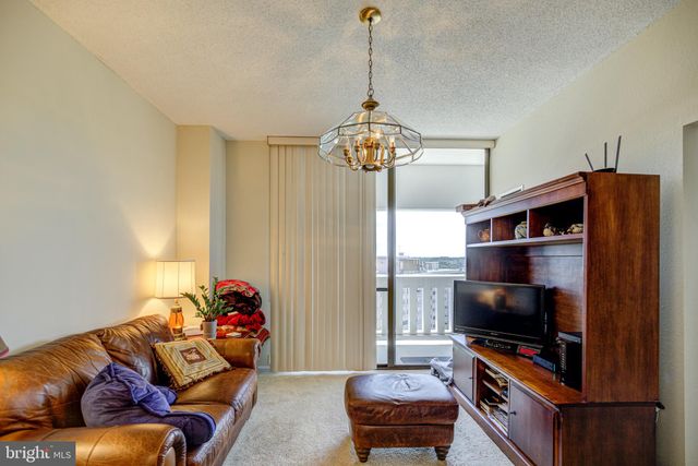 a living room with furniture a piano and a window