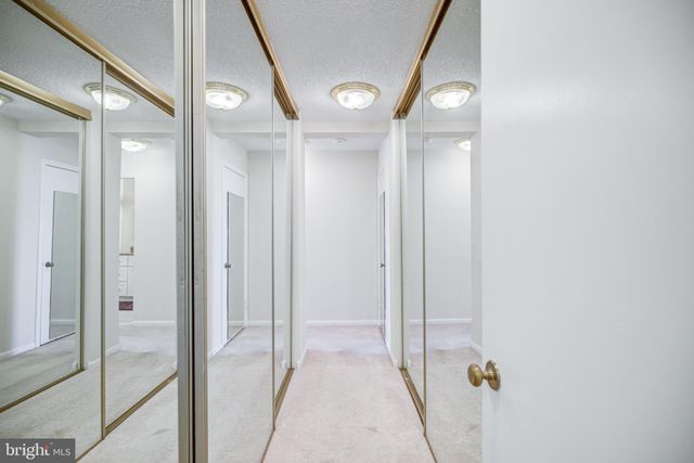 a view of hallway with closet