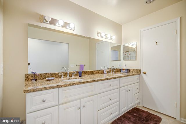 a bathroom with a shower a sink and a mirror