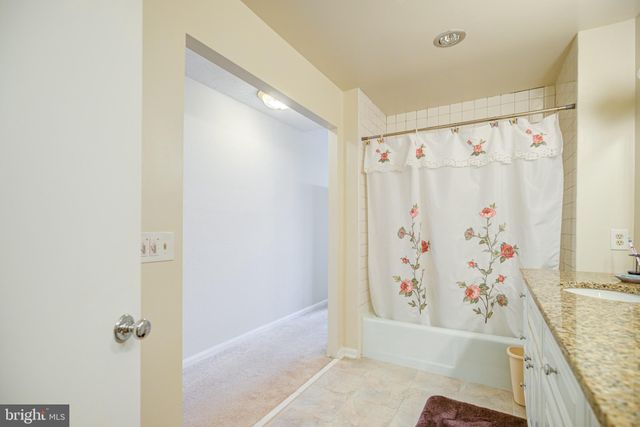 a view of a hallway with furniture and a livingroom