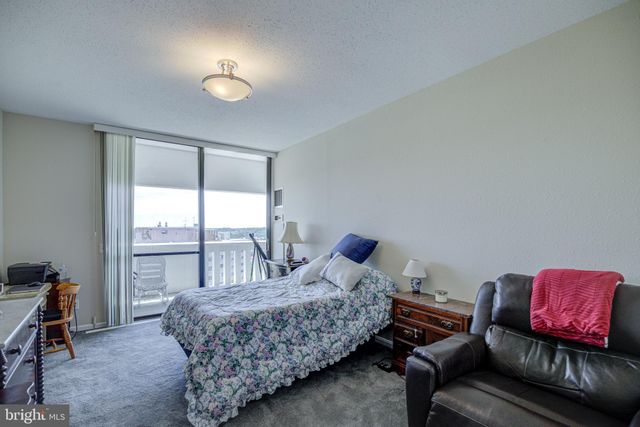 a bedroom with a bed and a desk